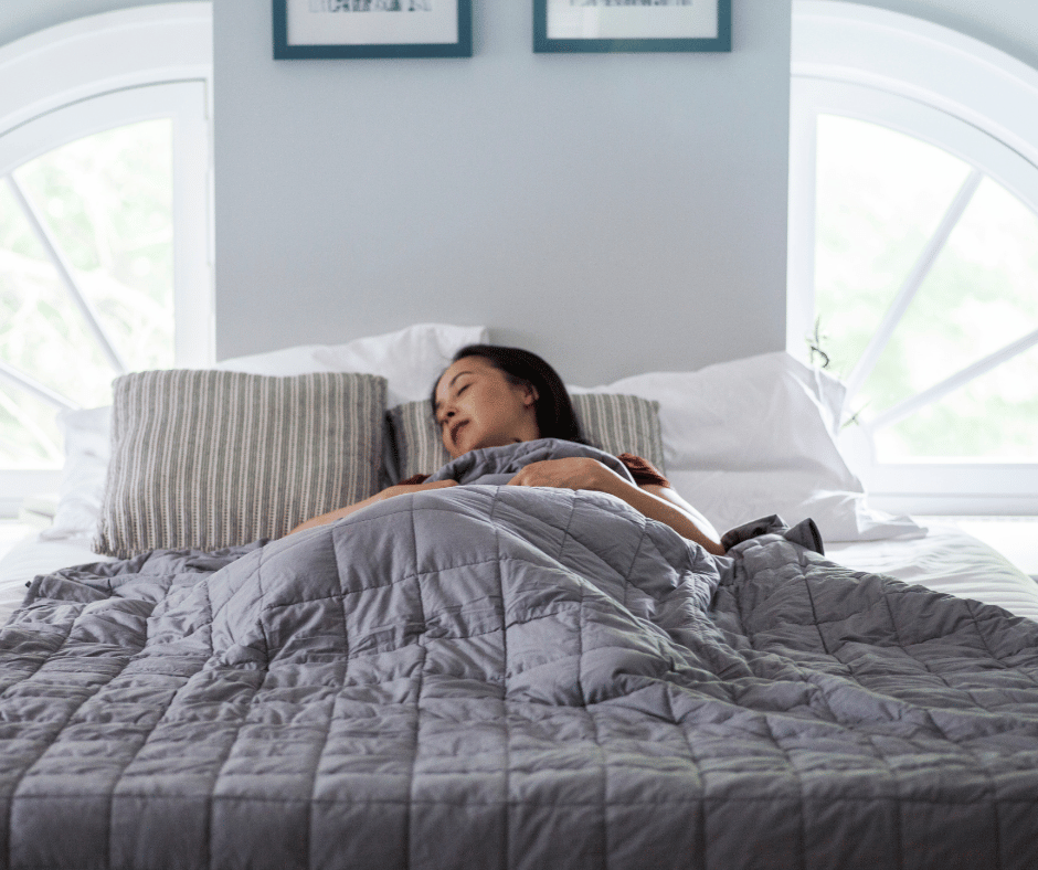 Image of woman sleeping under weighted blanket.